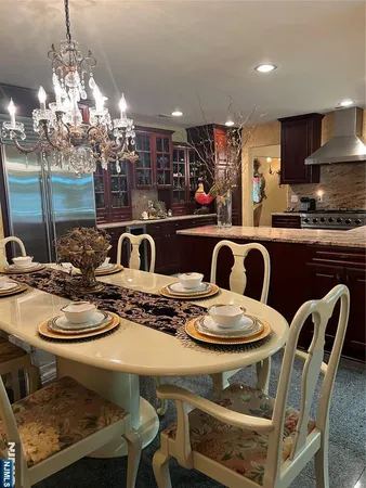 a kitchen with white cabinets and window