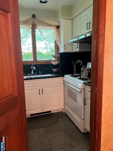 a kitchen with a refrigerator and a sink