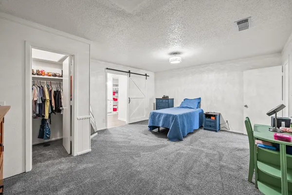 a bedroom with furniture and closet