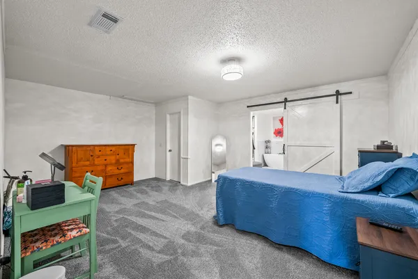 a bed room with a bed window and mirror