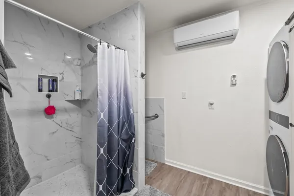 a bathroom with a toilet and a shower