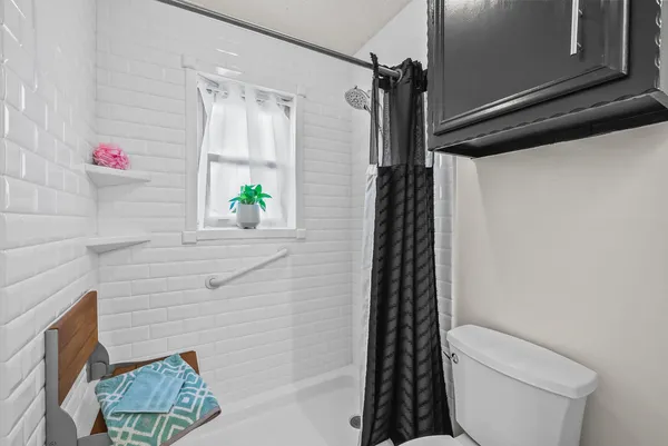 a bathroom with a toilet and shower