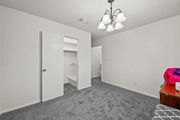 a view of a chandelier in big room and chandelier