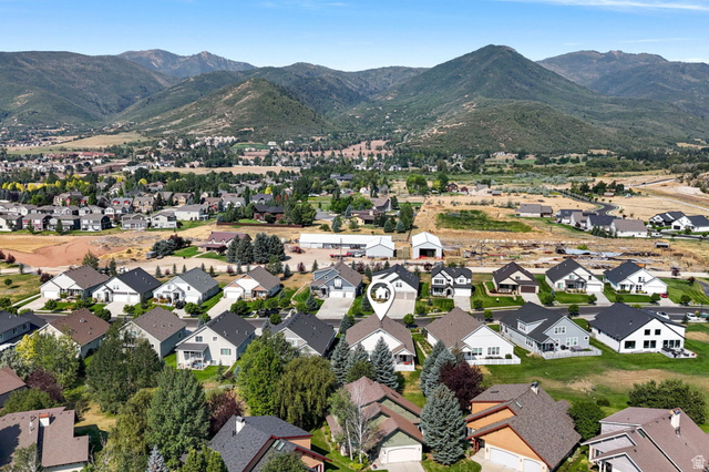 1238 Canyon View Road Midway, UT 84049 - Photo 33 of 33 Established residential community nestled in a verdant valley, featuring multiple single-family homes with contemporary architectural styling, dark composition roofing, and manicured landscaping
