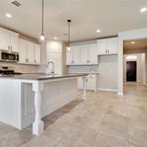a kitchen with stainless steel appliances a refrigerator sink and microwave