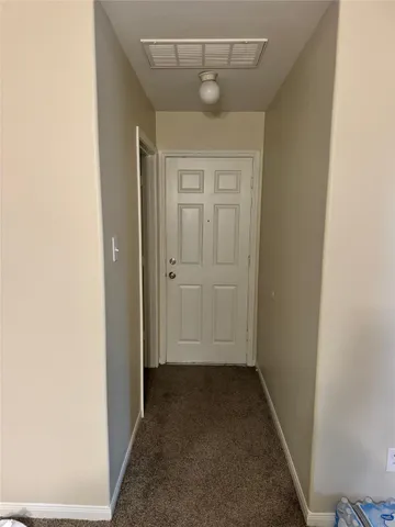 front view of a bathroom with a sink and a mirror