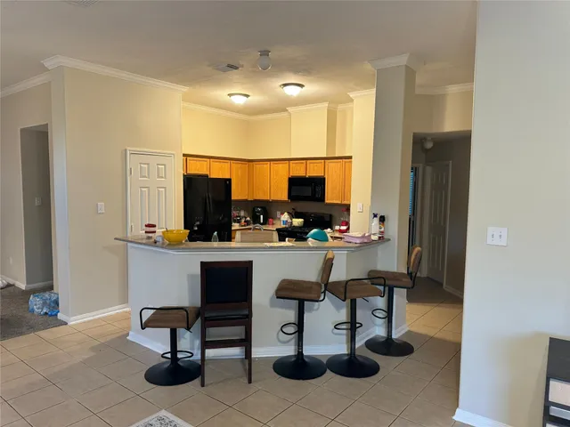 a kitchen with a sink cabinets and dining table chair