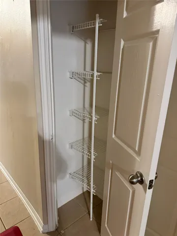a view of a house with a window and potted plants