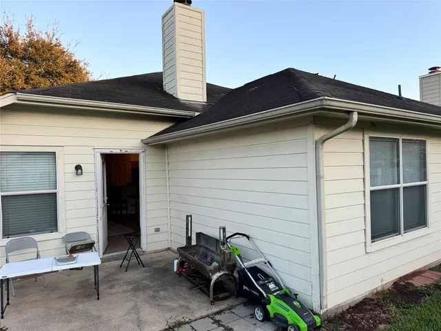 a view of a backyard with wooden fence