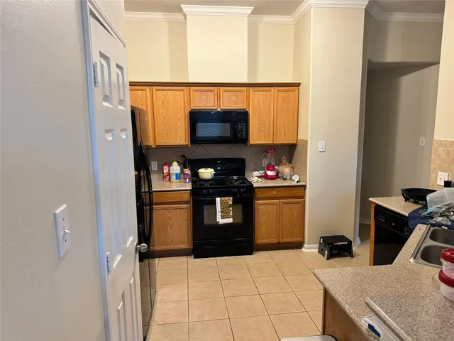 a kitchen with stainless steel appliances a stove and a microwave