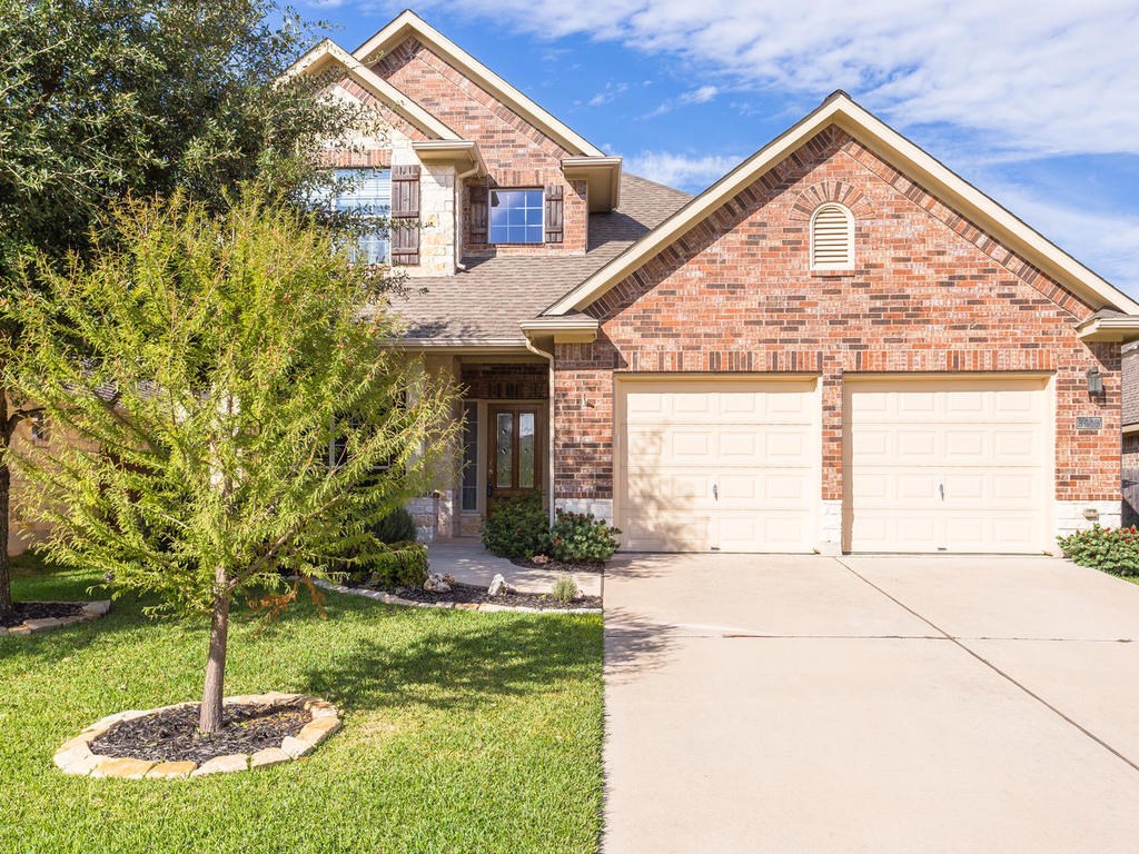 a front view of a house with a yard
