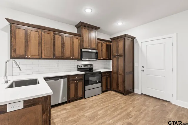 a kitchen with a sink stove and refrigerator