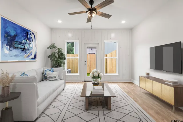 a living room with furniture and a flat screen tv