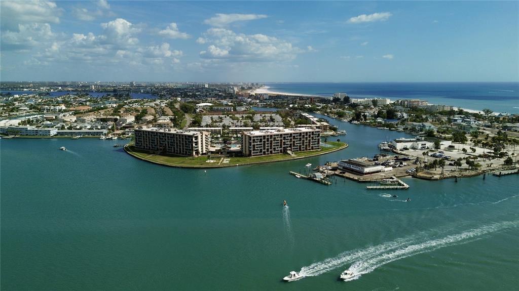 13343 Gulf Boulevard, Unit C9 Madeira Beach, FL 33708 - Photo 15 of 17 a view of a ocean with boats and trees in the background
