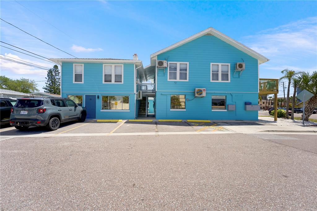 13343 Gulf Boulevard, Unit C9 Madeira Beach, FL 33708 - Photo 16 of 17 a front view of a house with a yard