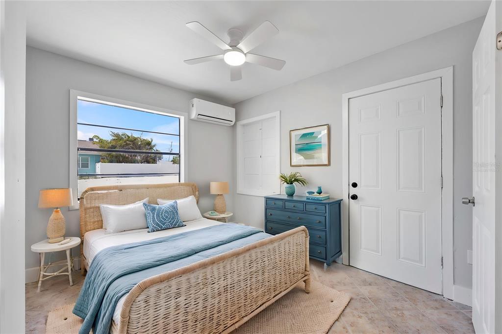 13343 Gulf Boulevard, Unit C9 Madeira Beach, FL 33708 - Photo 3 of 17 a bedroom with a large bed and a chandelier