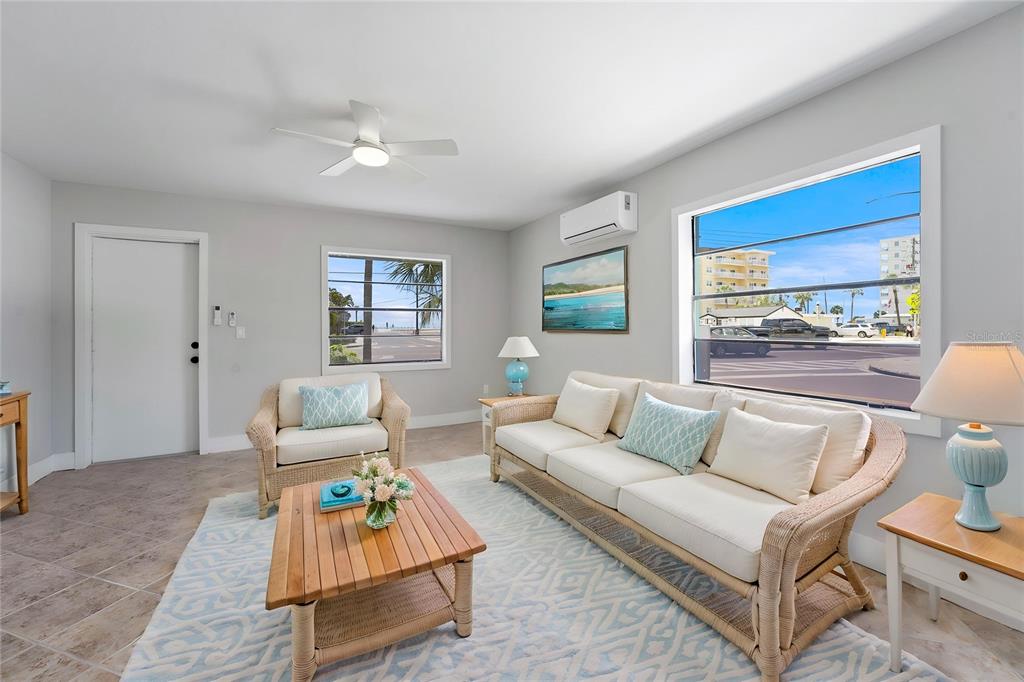 13343 Gulf Boulevard, Unit C9 Madeira Beach, FL 33708 - Photo 4 of 17 a living room with furniture and a potted plant