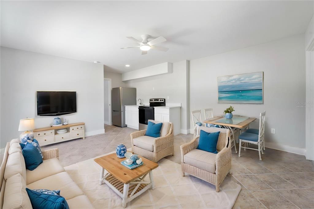 13343 Gulf Boulevard, Unit C9 Madeira Beach, FL 33708 - Photo 5 of 17 a living room with furniture and a flat screen tv