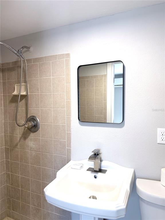 13343 Gulf Boulevard, Unit C9 Madeira Beach, FL 33708 - Photo 6 of 17 a bathroom with a sink toilet and shower