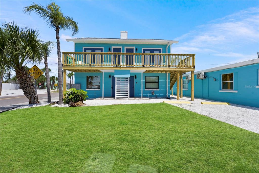 13343 Gulf Boulevard, Unit C9 Madeira Beach, FL 33708 - Photo 9 of 17 a front view of a house with a garden