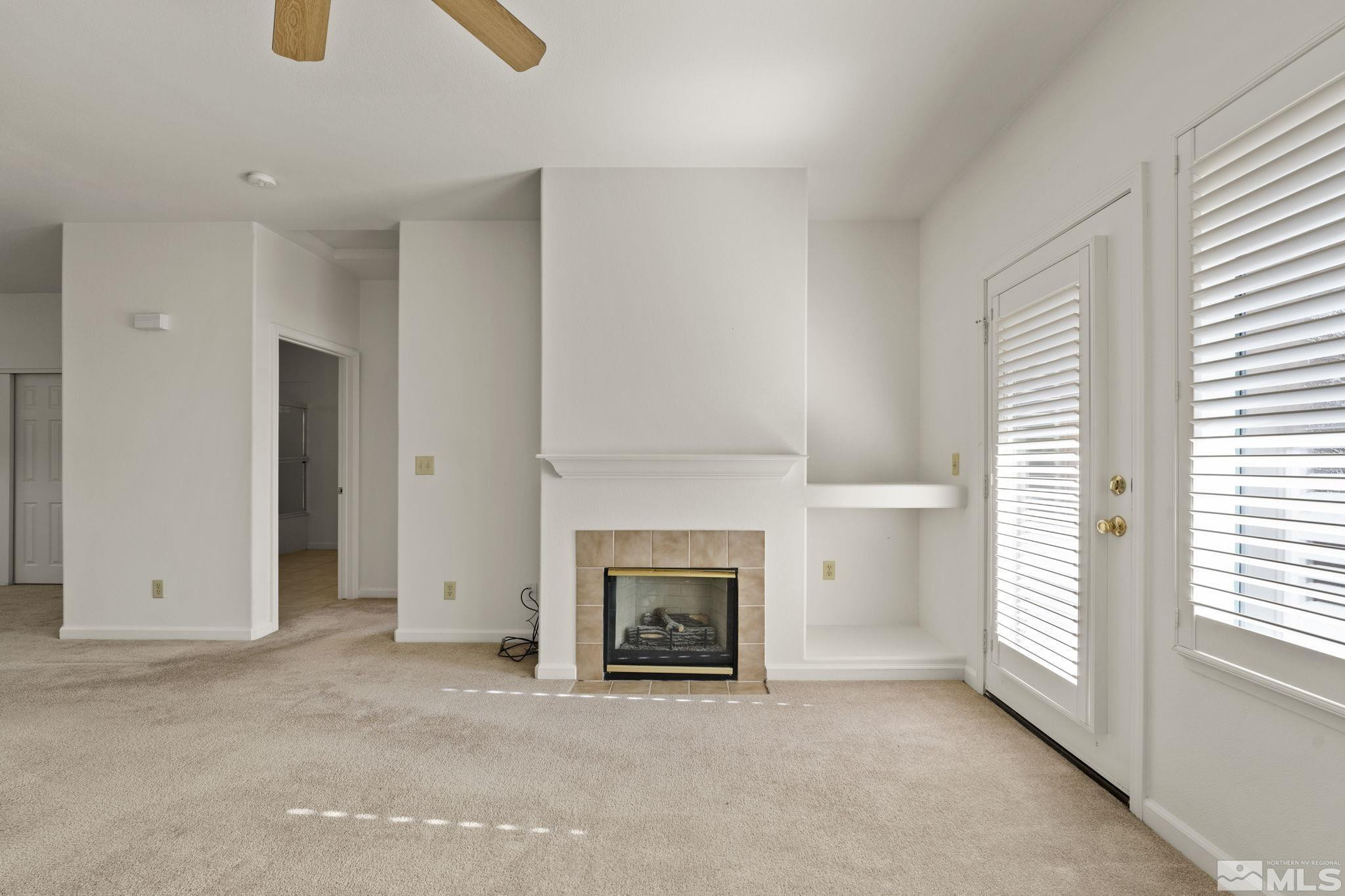 900 South Meadows Parkway, Unit 3423 Reno, NV 89521 - Photo 6 of 37 an empty room with windows and fireplace