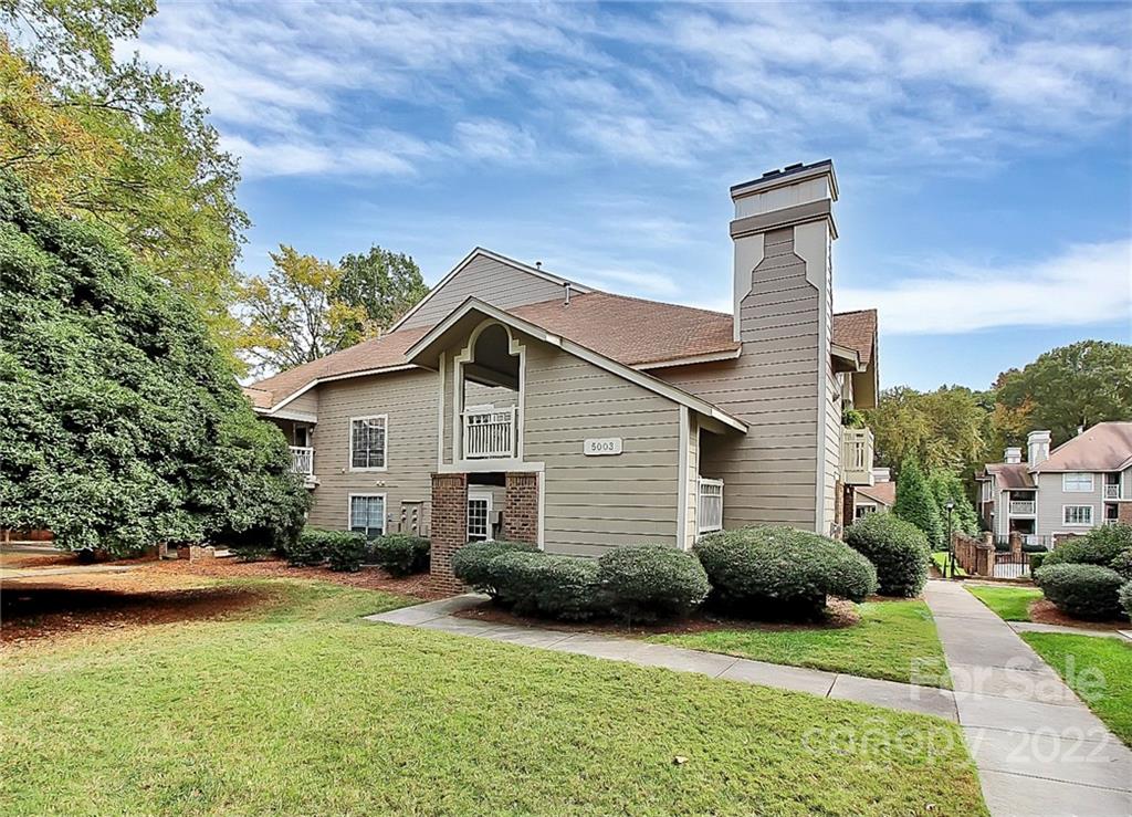 5003 Sharon Road, Unit N Charlotte, NC 28210 - Photo 1 of 11 a view of a house with backyard and garden