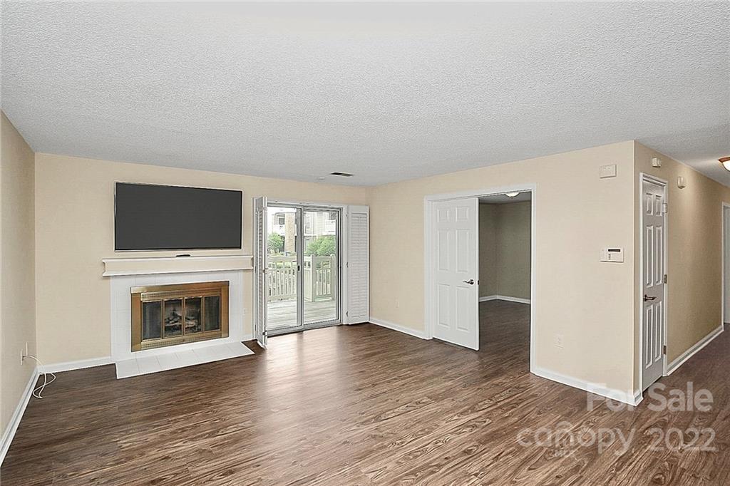 5003 Sharon Road, Unit N Charlotte, NC 28210 - Photo 4 of 11 a living room with furniture fireplace and flat screen tv