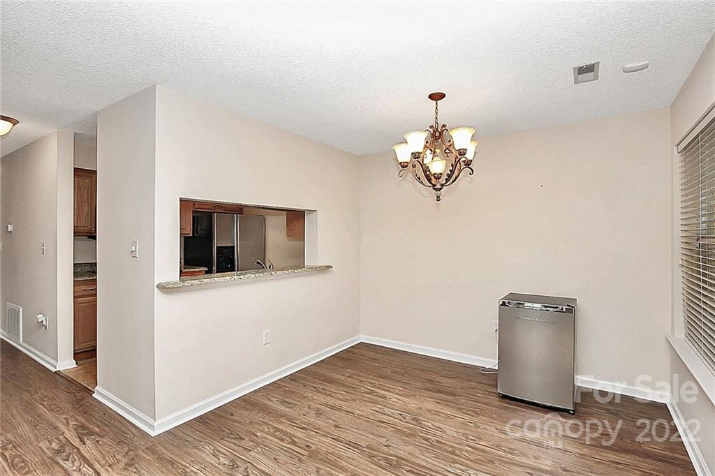 5003 Sharon Road, Unit N Charlotte, NC 28210 - Photo 5 of 11 a room with wooden floor workspace and a window