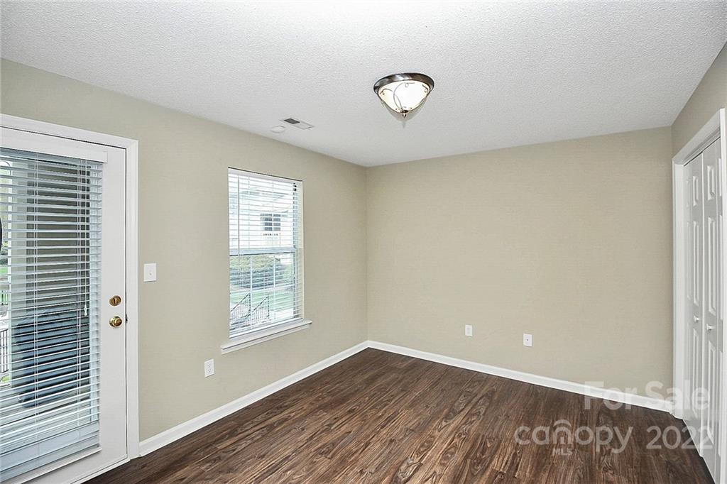 5003 Sharon Road, Unit N Charlotte, NC 28210 - Photo 8 of 11 a view of a livingroom with wooden floor and window