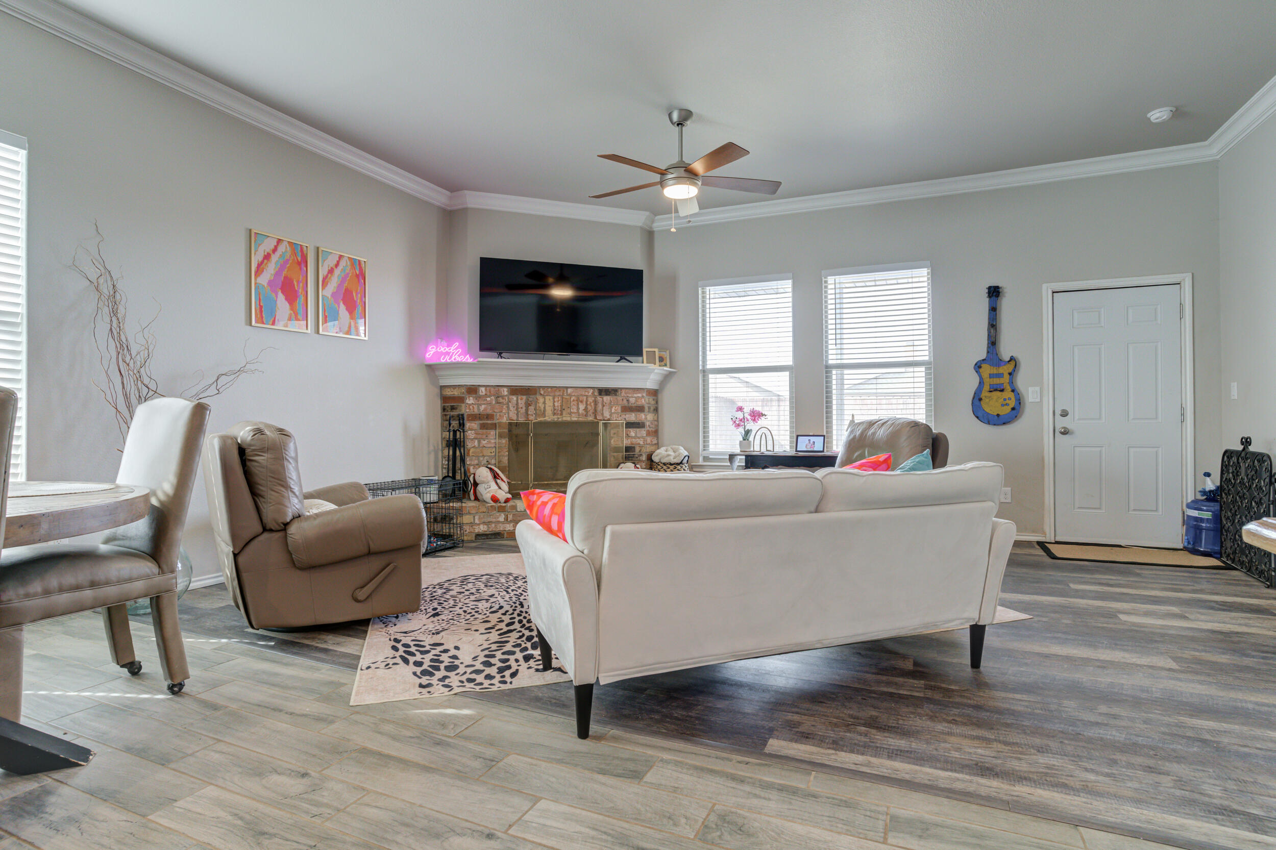 6818 40th Street Lubbock, TX 79407 - Photo 13 of 43 a living room with furniture a flat screen tv and a fireplace