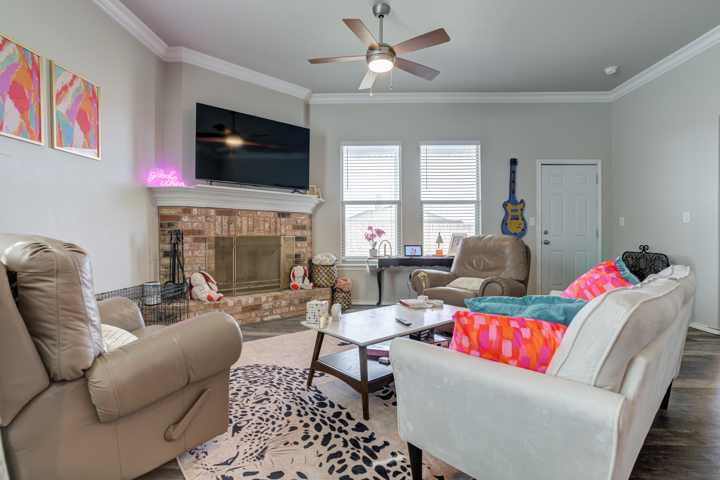 6818 40th Street Lubbock, TX 79407 - Photo 14 of 43 a living room with fireplace furniture and a flat screen tv
