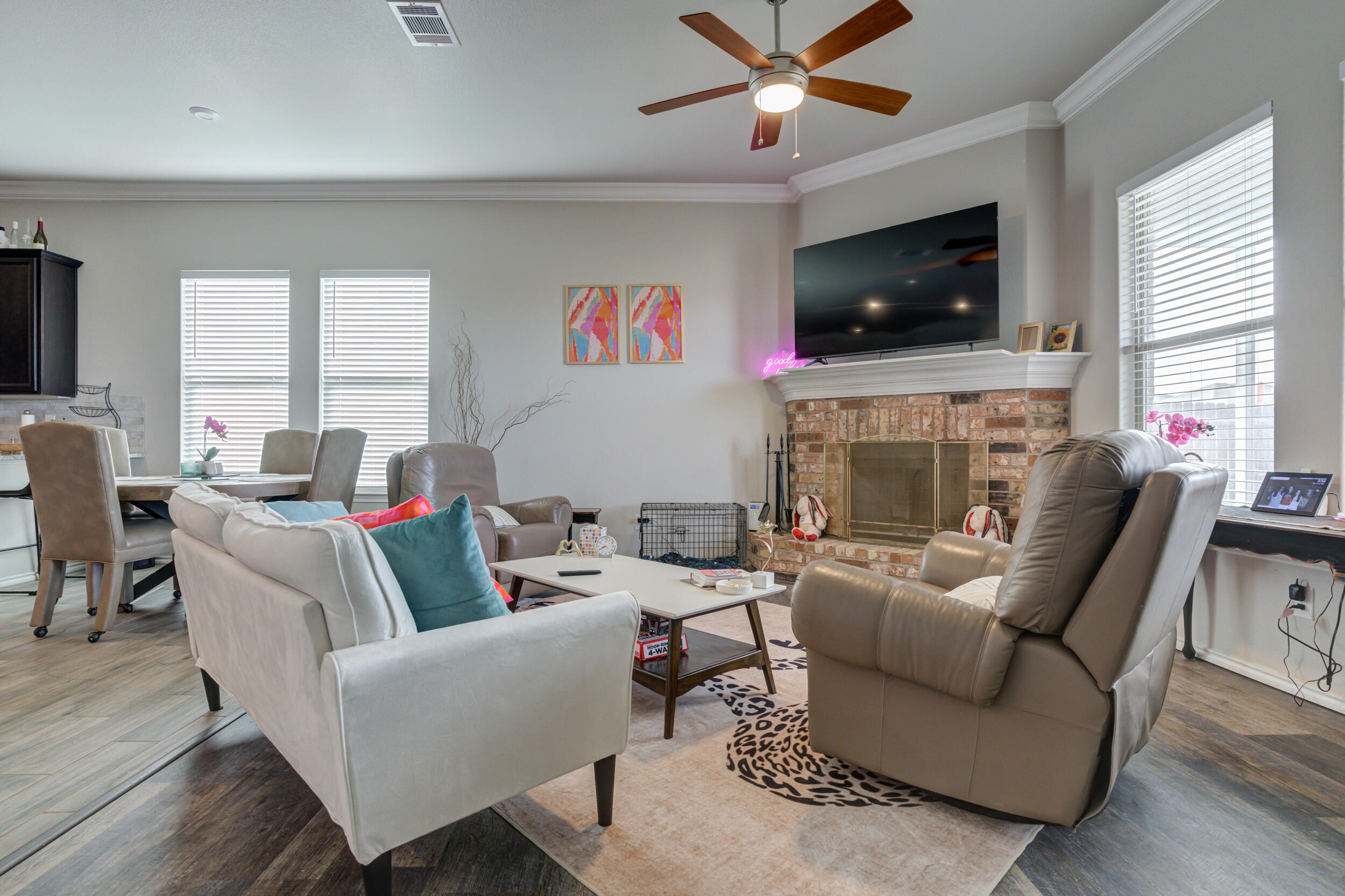 6818 40th Street Lubbock, TX 79407 - Photo 15 of 43 a living room with fireplace furniture and a flat screen tv