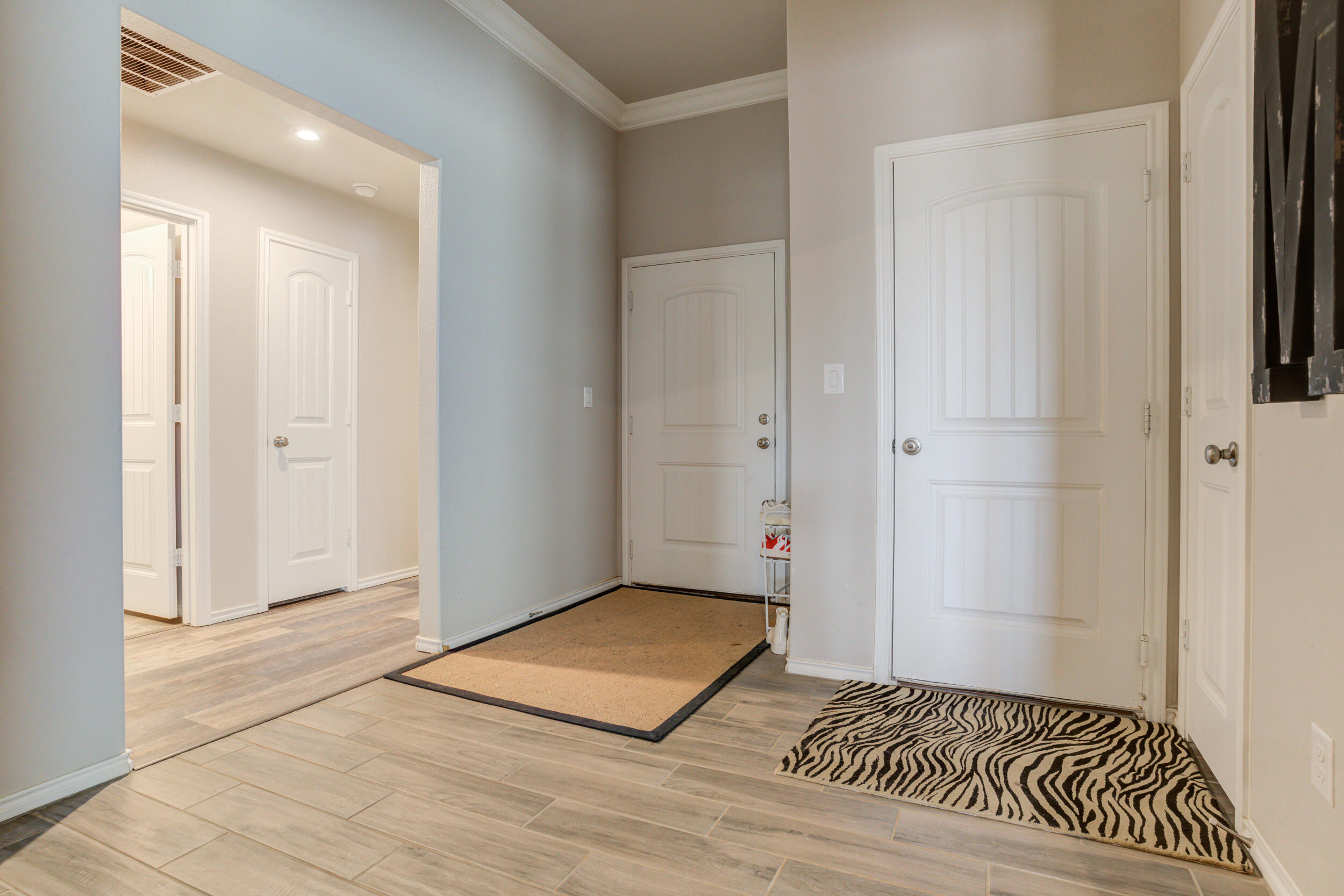 6818 40th Street Lubbock, TX 79407 - Photo 2 of 43 a view of a bedroom with wooden floor and a bathroom