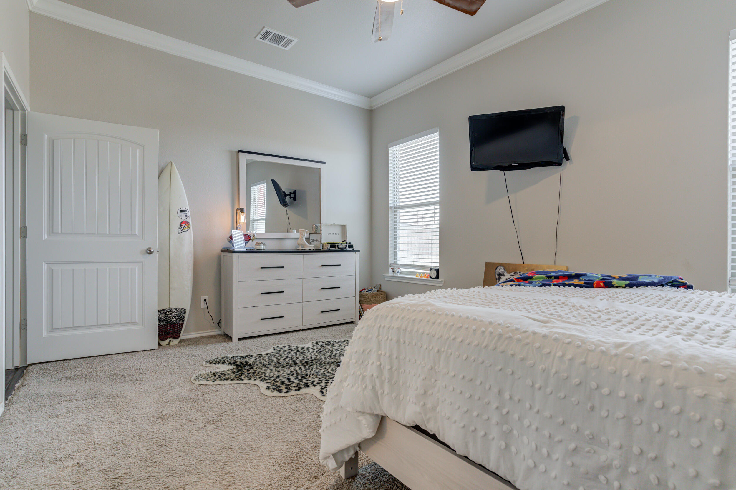 6818 40th Street Lubbock, TX 79407 - Photo 22 of 43 a bedroom with a bed and a flat screen tv