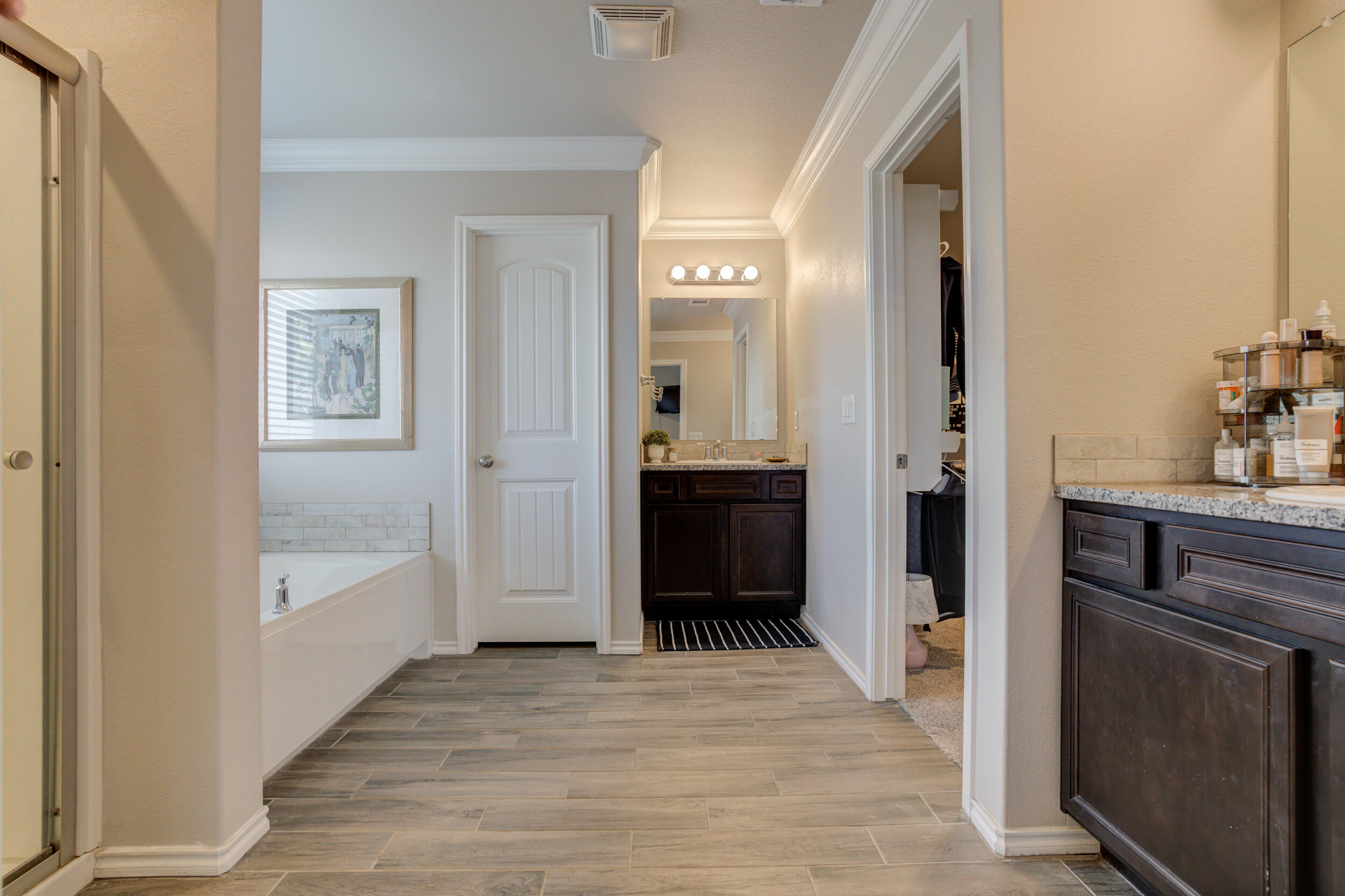 6818 40th Street Lubbock, TX 79407 - Photo 23 of 43 a bathroom with a bathtub and a shower