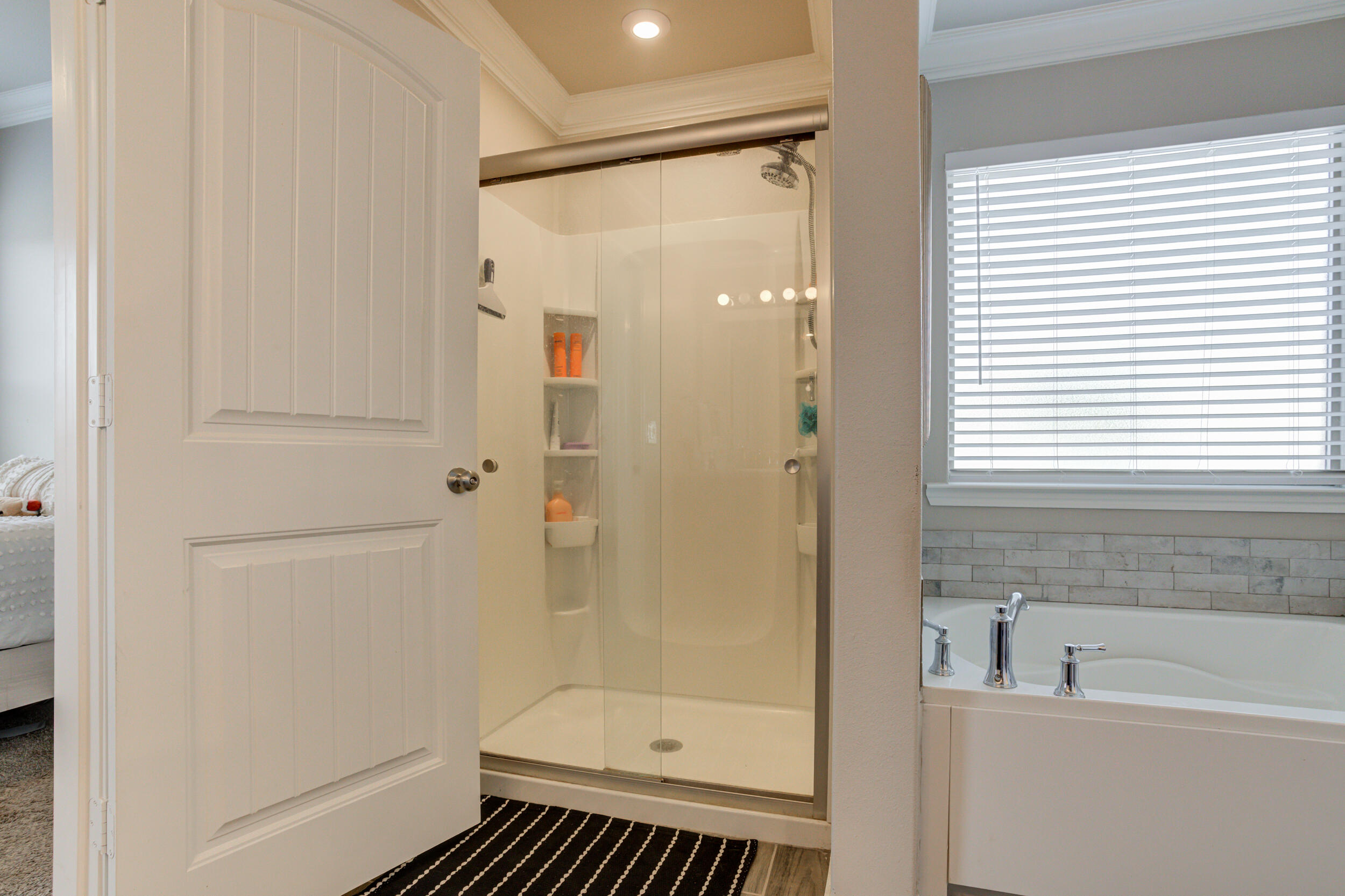 6818 40th Street Lubbock, TX 79407 - Photo 26 of 43 a bathroom with a shower and a bathtub