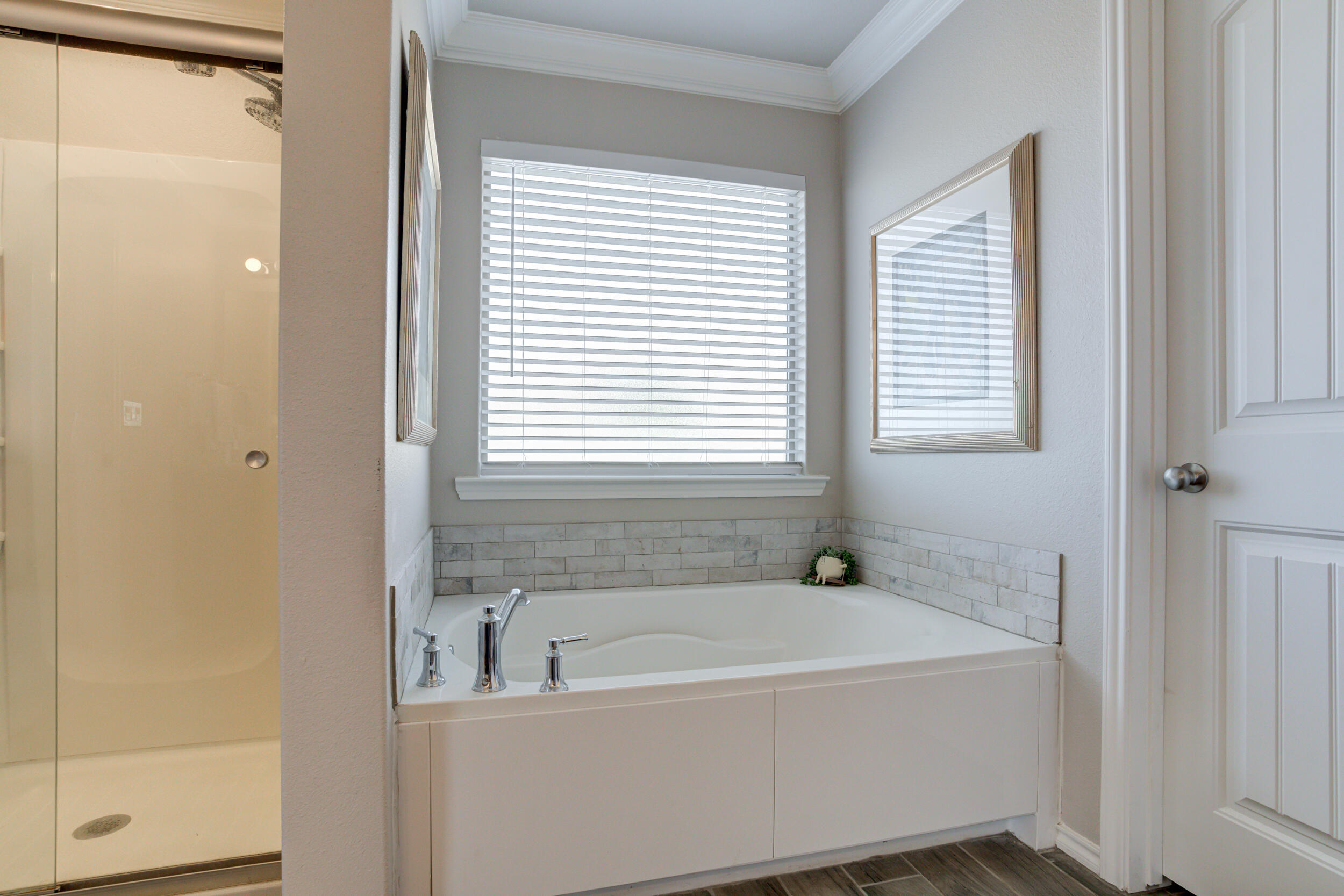 6818 40th Street Lubbock, TX 79407 - Photo 27 of 43 a white bath tub sitting next to a window