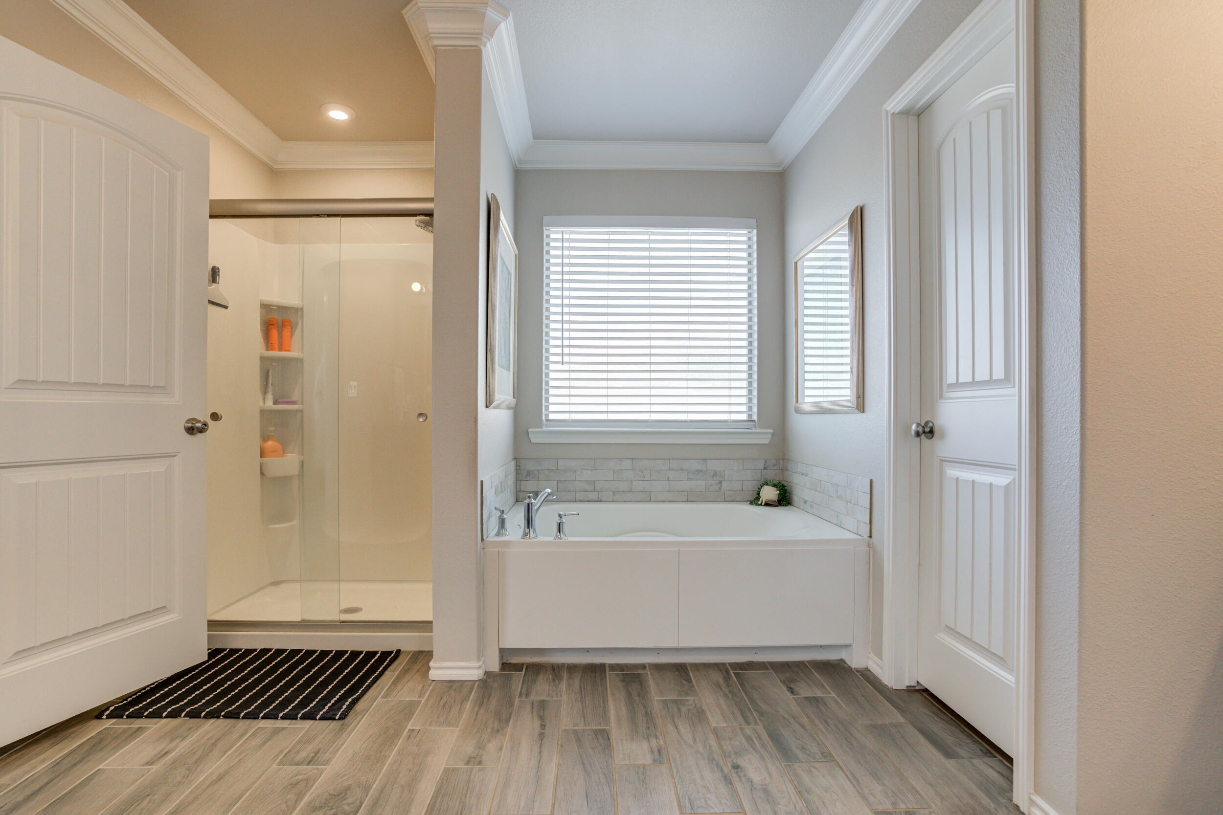 6818 40th Street Lubbock, TX 79407 - Photo 28 of 43 a bathroom with a bathtub and a shower