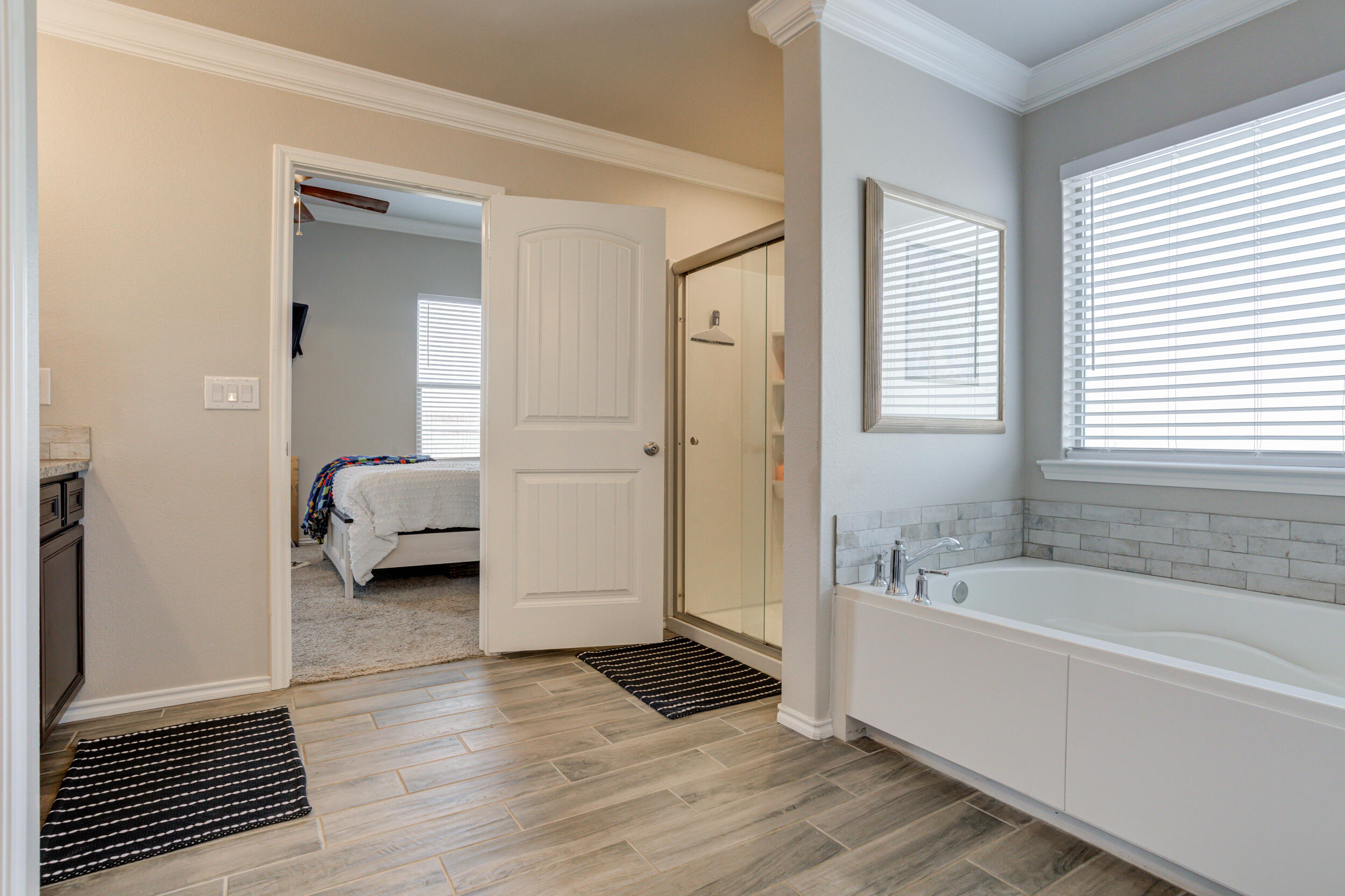 6818 40th Street Lubbock, TX 79407 - Photo 30 of 43 a spacious bathroom with a tub shower and a sink
