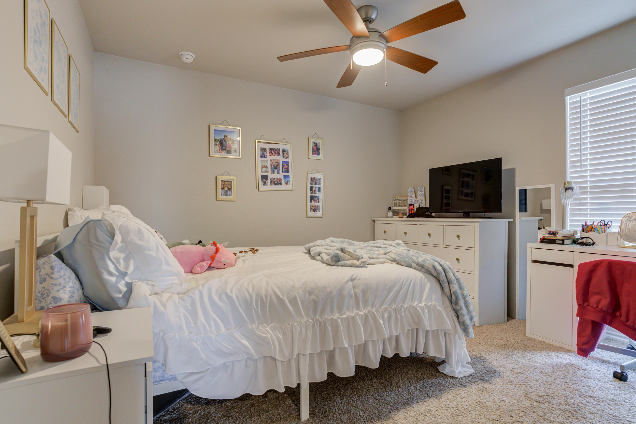 6818 40th Street Lubbock, TX 79407 - Photo 34 of 43 a bedroom with a bed and a flat screen tv