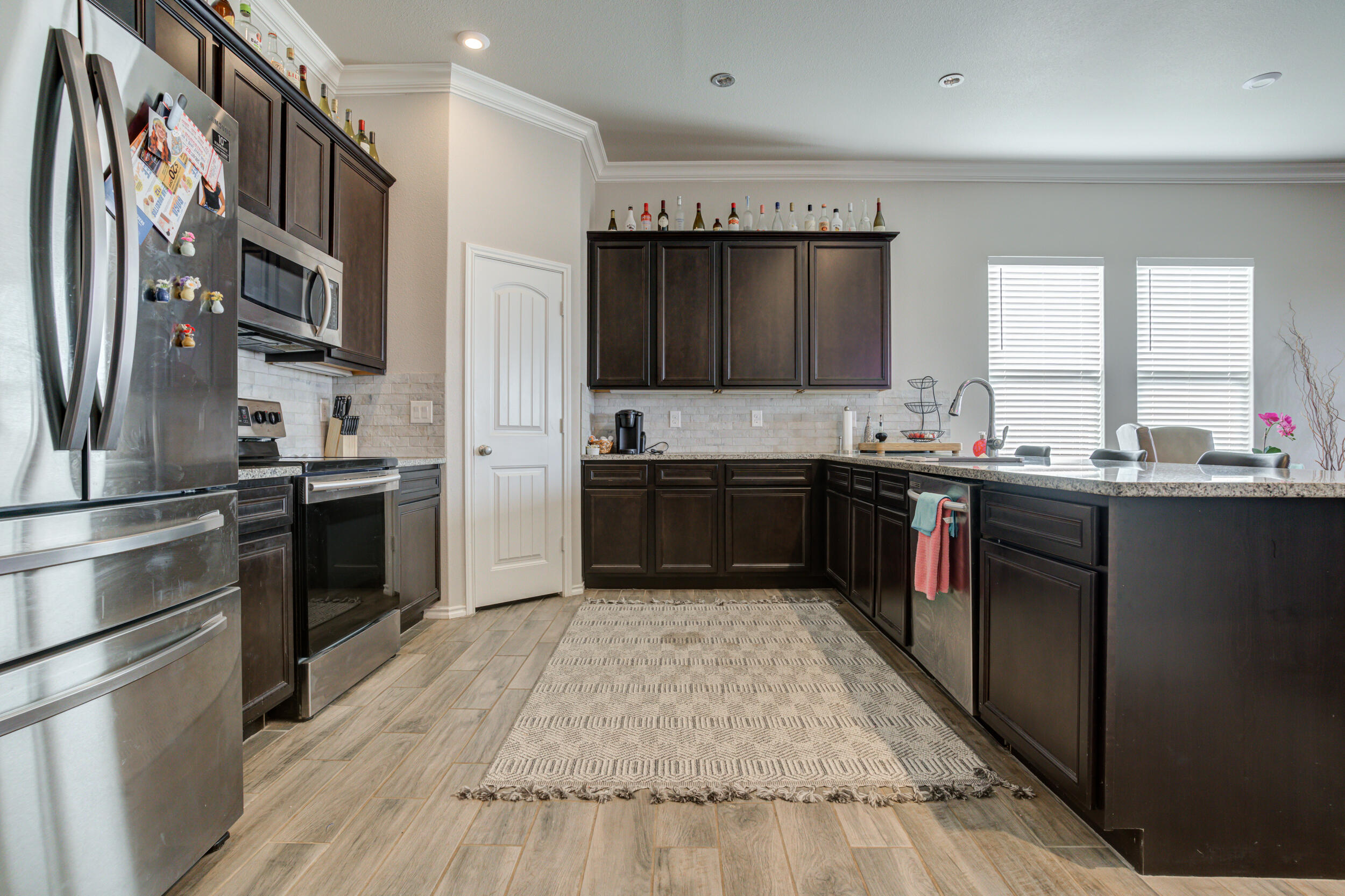 6818 40th Street Lubbock, TX 79407 - Photo 5 of 43 a kitchen with stainless steel appliances granite countertop a stove a sink dishwasher and a refrigerator