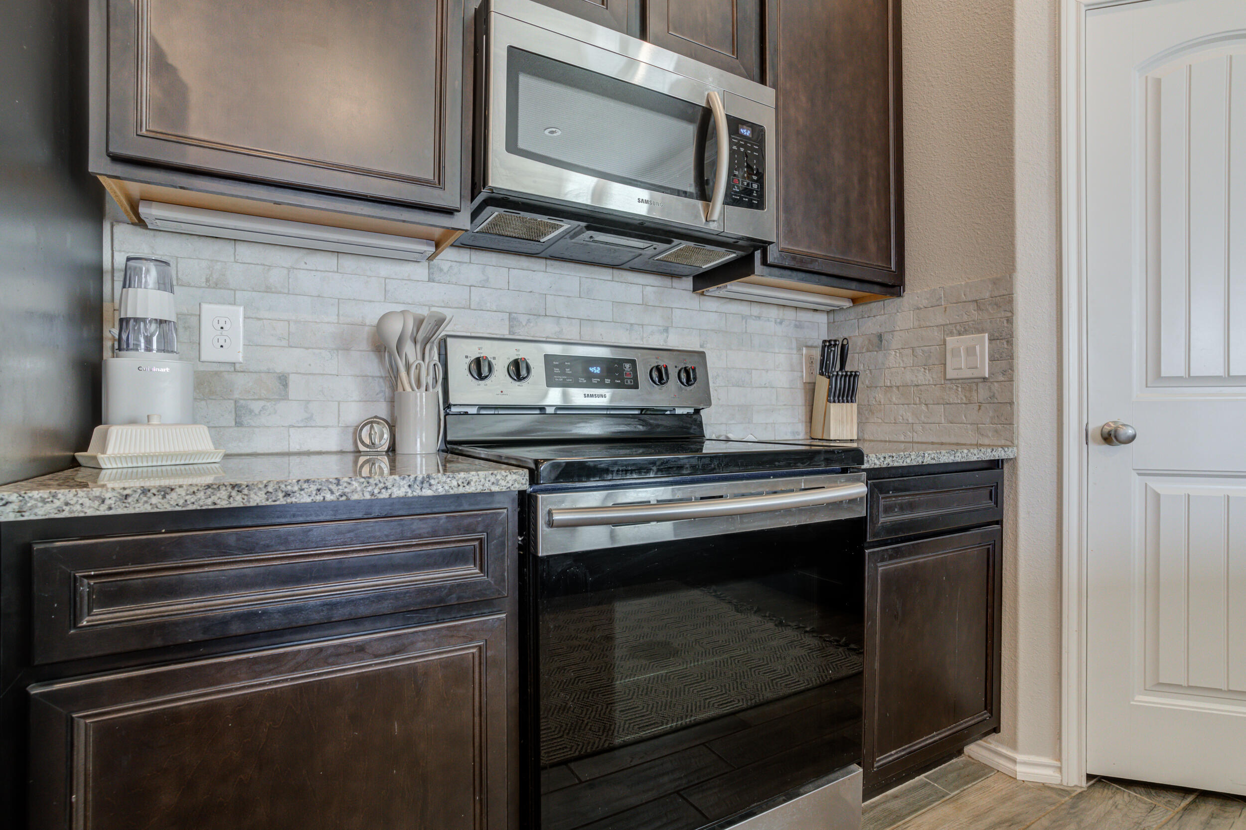6818 40th Street Lubbock, TX 79407 - Photo 7 of 43 a stove top oven sitting inside of a kitchen