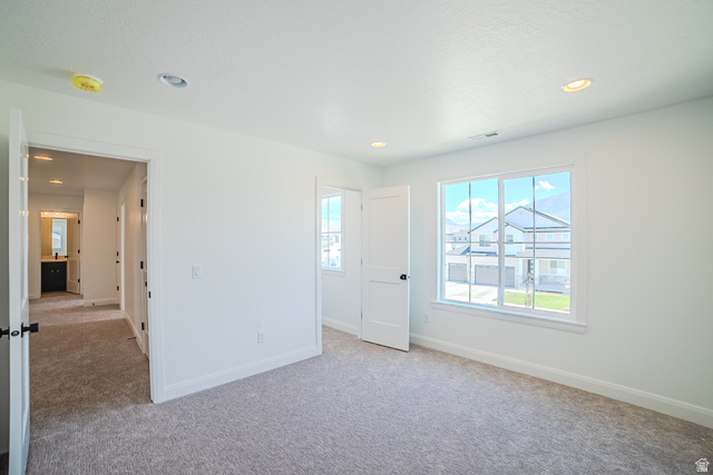 45 North Scarlet Maple Road, Unit 4317 Vineyard, UT 84059 - Photo 20 of 35 Spacious room featuring light gray carpet flooring, white walls, and a large multi-pane window