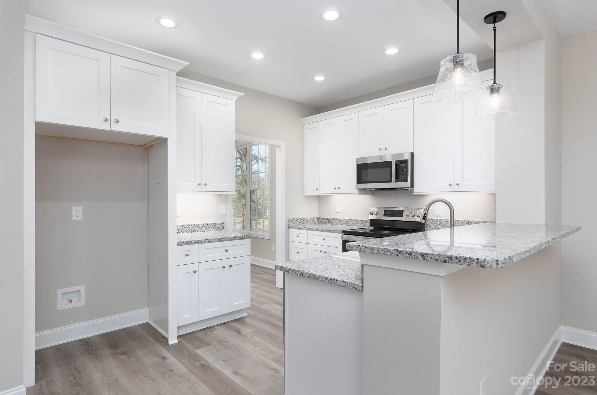 4434 Culp Road Edgemoor, SC 29712 - Photo 7 of 36 a kitchen with stainless steel appliances granite countertop a refrigerator a stove a sink and white cabinets with wooden floor