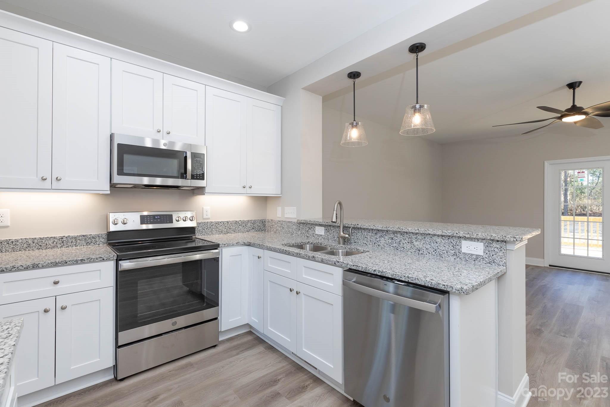 4434 Culp Road Edgemoor, SC 29712 - Photo 8 of 36 a kitchen with stainless steel appliances granite countertop a stove and a white cabinets