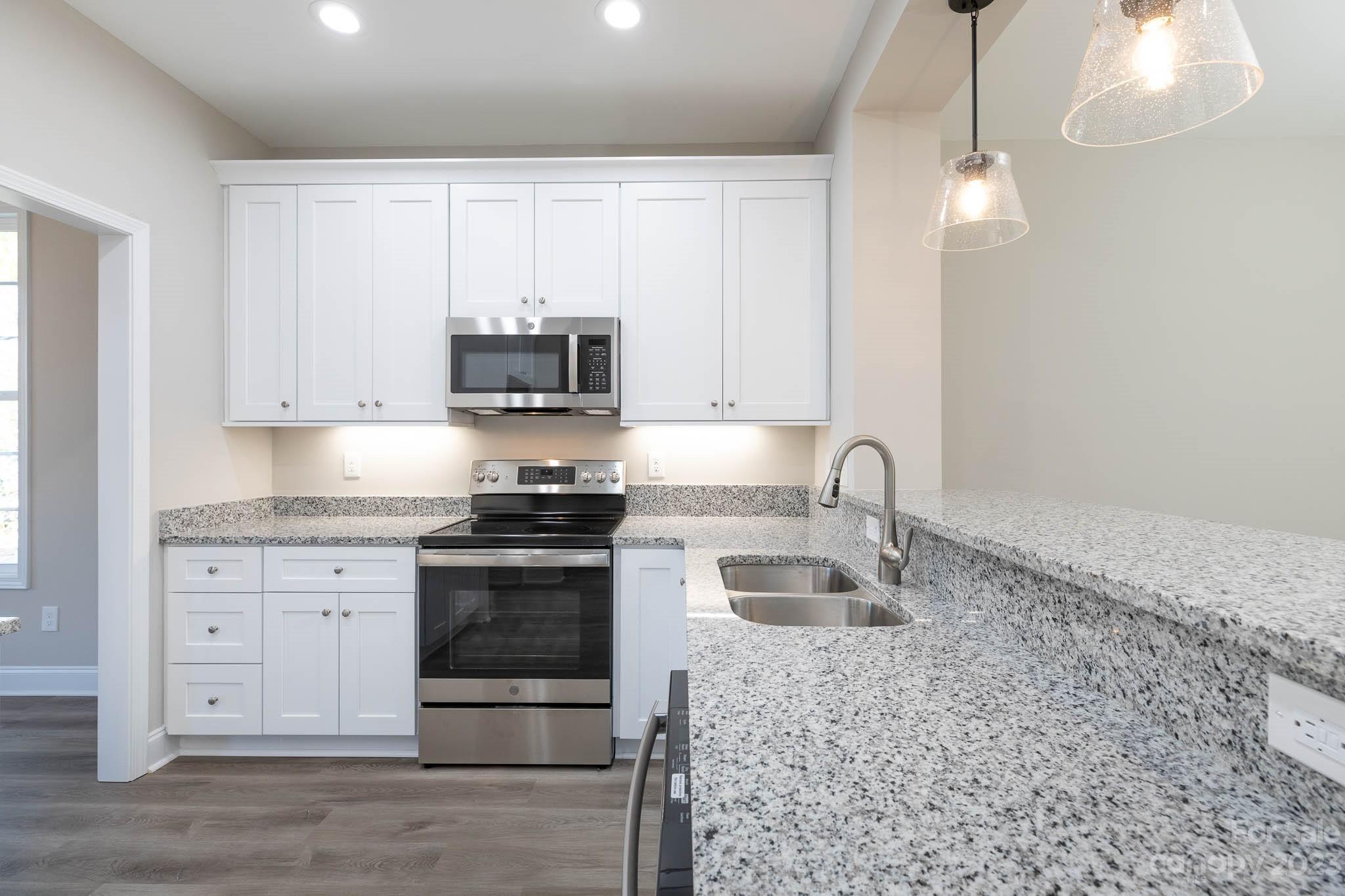4434 Culp Road Edgemoor, SC 29712 - Photo 9 of 36 a kitchen with stainless steel appliances granite countertop a stove a sink and a microwave