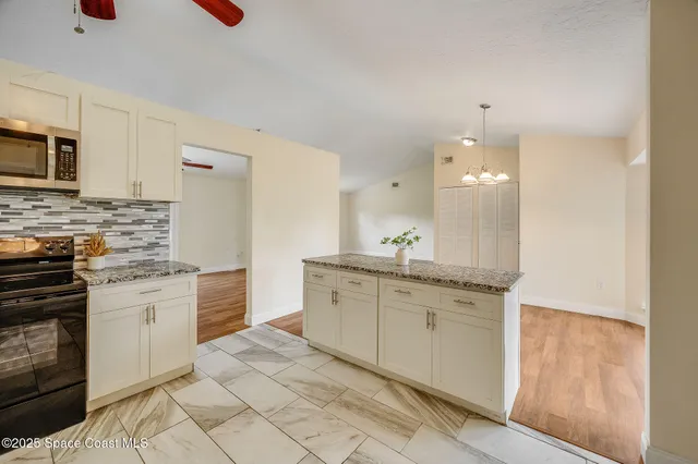 a bathroom with a granite countertop sink a toilet and a mirror