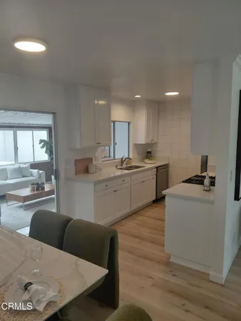 a kitchen with a stove a sink and a refrigerator