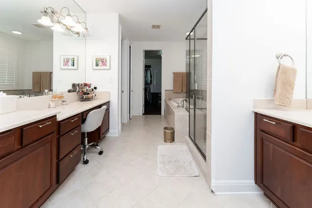 a en suite bathroom with a double vanity sink a mirror and shower