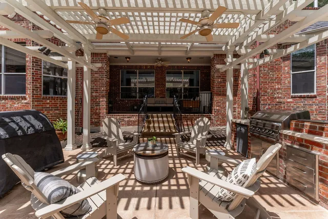 a view of a patio with table and chairs and potted plants
